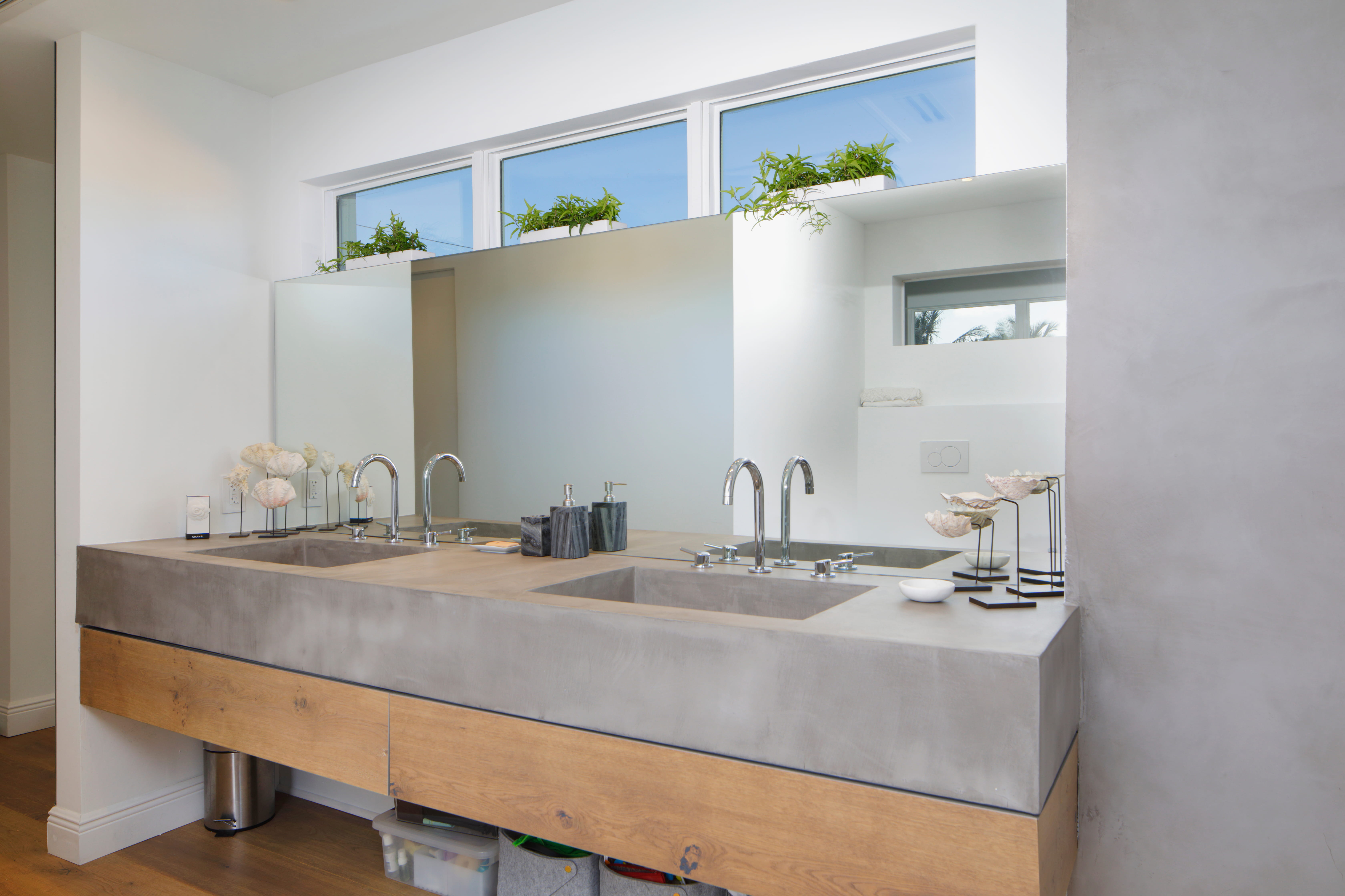 Microcement bathroom with arched shower niche and tall walls — Los Angeles luxury remodel