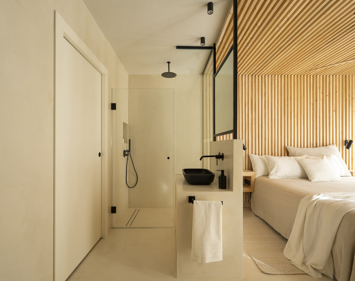 Microcement large walk-in shower with arched entry — seamless grey finish Los Angeles